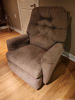 Front view of grey-brown fabric rocker recliner chair