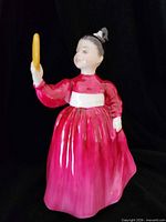 Front view of Royal Doulton Vanity figurine showing dress colour and mirror