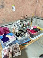 Overall lot showing thread rack, pattern envelopes, fabric bins, tools