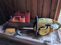 Chainsaw with bar, two fuel cans, chain sharpener kit