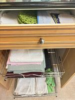 Drawer with stacked placemats, tablecloths and napkins