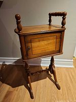 Front view showing single door, turned legs and feet