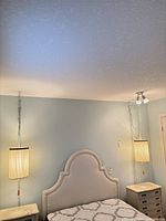 Bedroom view showing both hanging swag lamps above nightstands