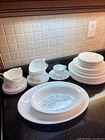 Grouped view of entire dinnerware set on countertop