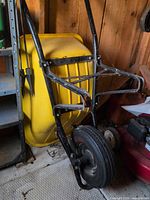 Close view of front frame, wheel and yellow tray back