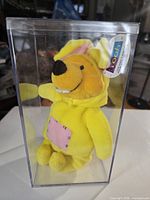 Front view of Pooh plush in display case