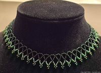 Full view of choker on display form showing bead pattern and overall length