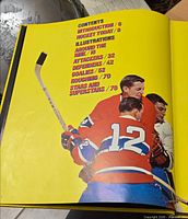 Book interior showing illustrated contents page with hockey players