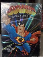 Front view of sealed holographic slipcase showing Superman artwork and title