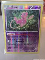 Front of sleeved Mew reverse holo card