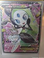 Front of Meloetta EX card in sleeve