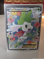 Front view of Shaymin EX RC21/RC25 card standing upright showing artwork, HP and move text
