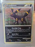 Front of sleeved Umbreon card showing artwork, text, HP, attacks Moonlight Fang and Quick Blow