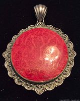 front view showing coral cabochon and ornate silver frame