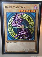 Front of Dark Magician card in sleeve showing title, artwork, stats and set code