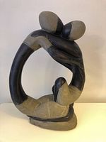 Front view of two-tone stone lovers sculpture