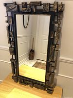 Front view of brutalist framed mirror on table