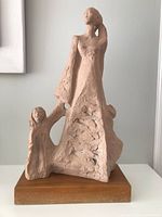 Front view of plaster sculpture on wood base
