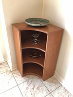 full view of cabinet showing curved front and shelves