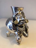 Front view of silver Toltec woman vessel sculpture