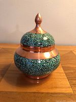 Front view of copper bowl with turquoise inlay and lid