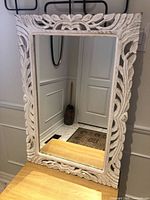 Full view of mirror showing carved frame and glass