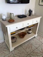 Front view showing entire console with three drawers and lower shelf