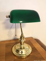 Lamp front view showing green shade and brass base
