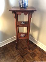 Full view of oak plant stand showing three tiers and overall form