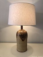 Full view of lamp with shade illuminated