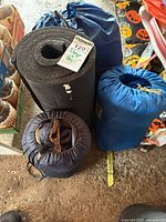 Black closed-cell foam pad, blue and navy drawstring sacks