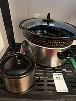 Both mini slow cookers with lids visible