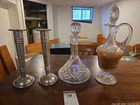 Group shot of decanter, cruet and two candlesticks