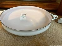 Top view of Dansk 14-inch white enameled braiser showing interior and rim