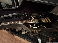 Guitar in open hard case showing full length and headstock