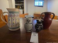 Group shot of four pottery pieces on table