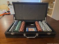 Open leatherette case showing chips, cards, dice, dealer button