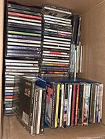 Full box showing two stacks of approximately 40 CDs in various cases