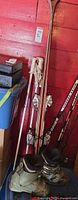 Full view of skis, poles and boots leaning against wall