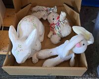 All three bunnies inside box: papier-mâché rabbit, plush long-limbed rabbit, small floral fabric rabbit