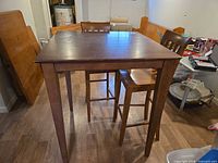 Overall view of square pub-height table with two matching chairs