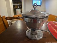 Complete chafing dish set assembled with lid, handle, stand and burner visible
