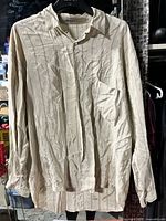 Full front view of shirt on hanger showing color, stripes, pocket, long sleeves
