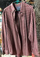Front view of plaid flannel shirt on hanger