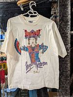 Full view of T-shirt hanging to show overall design and condition