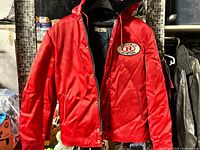 Front view of red Calberta jacket with Richfield Aviation patch and hood