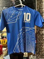 Front view of blue Carbrini soccer shirt on hanger