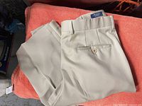 Full view of beige trousers folded