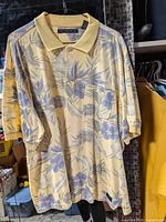 Front view of Cotton Reel men’s floral polo shirt