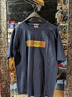 Full front view of navy Counter Culture T-shirt on hanger